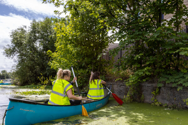 Two members of Smart canoe litter picking