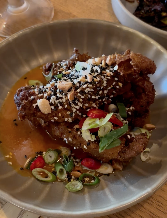 crispy kare kare chicken thighs with peanuts, chilli and spring onion